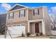 Two-story house with tan siding, brown door, and white garage door at 2262 Redstone Dr, York, SC 29745