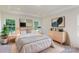 Main bedroom with queen bed, light wood dresser, and large windows at 242 Winford Rd, Troutman, NC 28116