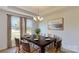 Bright dining room with dark wood table and seating for six, featuring large windows at 242 Winford Rd, Troutman, NC 28116