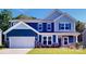 Two-story home with blue siding, white trim, and a landscaped lawn at 242 Winford Rd, Troutman, NC 28116