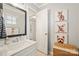 Bathroom featuring white vanity, framed mirror, colorful dog art, and neutral-colored tiles at 3332 Delaware Dr, Denver, NC 28037