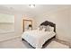 Bedroom featuring a large bed with a statement headboard, gold framed mirror, and plush carpeting at 3332 Delaware Dr, Denver, NC 28037