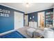 Bedroom with blue walls, white trim, closet and shelving unit at 3332 Delaware Dr, Denver, NC 28037