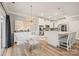 Bright eat-in kitchen with modern light fixture, white cabinets, and stainless steel appliances at 3332 Delaware Dr, Denver, NC 28037