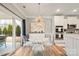 Dining area with modern light fixture, a sliding glass door, and white accent cabinets at 3332 Delaware Dr, Denver, NC 28037