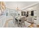 Elegant dining room features a crystal chandelier, modern artwork, and ample natural light at 3332 Delaware Dr, Denver, NC 28037