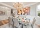 Chic dining room features a dazzling crystal chandelier, artwork, and table setting for elegant dining and entertaining at 3332 Delaware Dr, Denver, NC 28037