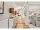 Bright entryway with hardwood floors, a mirrored console table, and view to living room at 3332 Delaware Dr, Denver, NC 28037