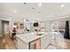 Kitchen with white cabinets, a center island, and a connected living room with fireplace at 3332 Delaware Dr, Denver, NC 28037