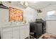 Laundry room featuring modern washer and dryer, white cabinets, decorative art, and shelving at 3332 Delaware Dr, Denver, NC 28037