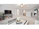 Bright living room with neutral walls, fan and plush carpeting, creating a cozy atmosphere at 3332 Delaware Dr, Denver, NC 28037