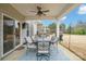 Covered patio with comfortable seating and ceiling fan, perfect for outdoor dining and relaxation with a view at 3332 Delaware Dr, Denver, NC 28037