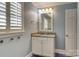 Light blue bathroom with single vanity, granite countertop, and tiled floor at 3821 Silver Bell Dr, Charlotte, NC 28211