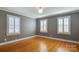 Bedroom with hardwood floors, plantation shutters, and gray walls at 3821 Silver Bell Dr, Charlotte, NC 28211