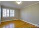 Bedroom with hardwood floors, plantation shutters, and neutral walls at 3821 Silver Bell Dr, Charlotte, NC 28211