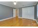 Bedroom with hardwood floors, plantation shutters, and white closet doors at 3821 Silver Bell Dr, Charlotte, NC 28211