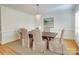 Formal dining room with hardwood floors, a wood table and neutral-toned chairs at 3821 Silver Bell Dr, Charlotte, NC 28211