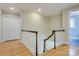 Upstairs hallway with hardwood floors and white doors at 3821 Silver Bell Dr, Charlotte, NC 28211