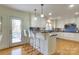 Modern kitchen with white cabinets, blue tile backsplash, and stainless steel appliances at 3821 Silver Bell Dr, Charlotte, NC 28211