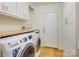 Laundry room with washer, dryer, and built-in cabinets at 3821 Silver Bell Dr, Charlotte, NC 28211