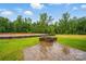 The backyard boasts a stone fire pit and lush greenery, perfect for outdoor gatherings at 4005 Grace Pointe Dr # 100, Wesley Chapel, NC 28079