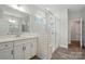 Bathroom showcasing a walk-in glass shower with a white double vanity sink at 4005 Grace Pointe Dr # 100, Wesley Chapel, NC 28079