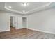 Bedroom with neutral paint, laminate flooring, and base molding with 2 open doors at 4005 Grace Pointe Dr # 100, Wesley Chapel, NC 28079