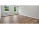 Bedroom features hardwood floors, and two large windows providing lots of natural light at 4005 Grace Pointe Dr # 100, Wesley Chapel, NC 28079