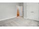 Spacious bedroom boasts soft carpeting and double doors for ample storage space at 4005 Grace Pointe Dr # 100, Wesley Chapel, NC 28079