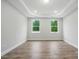Bright bedroom featuring hardwood floors, recessed ceiling lighting, and large windows at 4005 Grace Pointe Dr # 100, Wesley Chapel, NC 28079