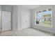 Bright bedroom with large window and neutral carpet offers a peaceful retreat at 4005 Grace Pointe Dr # 100, Wesley Chapel, NC 28079