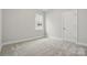 Cozy bedroom with soft carpet, single window, and a door leading to the hallway at 4005 Grace Pointe Dr # 100, Wesley Chapel, NC 28079
