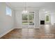 Dining area with hardwood floors, slider door to outside, view of fireplace, and pendant lighting at 4005 Grace Pointe Dr # 100, Wesley Chapel, NC 28079