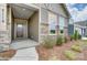 Inviting front porch with stone and siding exterior at 4005 Grace Pointe Dr # 100, Wesley Chapel, NC 28079