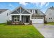 Charming new home with craftsman-style details, stone accents, and a two-car garage at 4005 Grace Pointe Dr # 100, Wesley Chapel, NC 28079