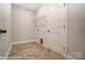 Functional laundry room with built-in shelving and tiled floor at 4005 Grace Pointe Dr # 100, Wesley Chapel, NC 28079