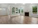 Bright living room with hardwood floors, fireplace, sliding doors, and plentiful natural light at 4005 Grace Pointe Dr # 100, Wesley Chapel, NC 28079