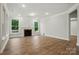 Bright living room features fireplace, wood floors, recessed lighting, and large windows at 4005 Grace Pointe Dr # 100, Wesley Chapel, NC 28079