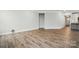 Spacious living room with hardwood floors. Features a wall opening and light-colored paint at 4005 Grace Pointe Dr # 100, Wesley Chapel, NC 28079