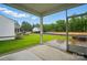 Covered patio boasts a smooth concrete floor and open screens offering views of the backyard at 4005 Grace Pointe Dr # 100, Wesley Chapel, NC 28079