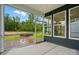 Covered patio boasts a smooth concrete floor and open screens offering views of the backyard at 4005 Grace Pointe Dr # 100, Wesley Chapel, NC 28079