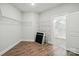 A walk-in closet is attached to a bathroom featuring built in shelving at 4005 Grace Pointe Dr # 100, Wesley Chapel, NC 28079