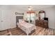 Cozy bedroom with ceiling fan and wood flooring at 409 Chinaberry Dr, China Grove, NC 28023