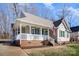 Tan house with white porch and green shutters at 409 Chinaberry Dr, China Grove, NC 28023