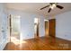 Spacious bedroom with hardwood floors, ceiling fan, and access to bathroom and closet at 41943 Gurley Rd, New London, NC 28127