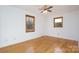 Well-lit bedroom featuring hardwood floors, ceiling fan and two windows at 41943 Gurley Rd, New London, NC 28127