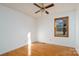 Simple bedroom with hardwood floors, ceiling fan, and window at 41943 Gurley Rd, New London, NC 28127