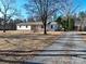 Ranch-style home with long driveway and mature trees at 41943 Gurley Rd, New London, NC 28127