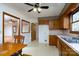 Kitchen with wood cabinets, passthrough to the dining area, and access to other rooms at 41943 Gurley Rd, New London, NC 28127