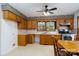 Galley style kitchen with wood cabinets, and built-in bench seating at 41943 Gurley Rd, New London, NC 28127